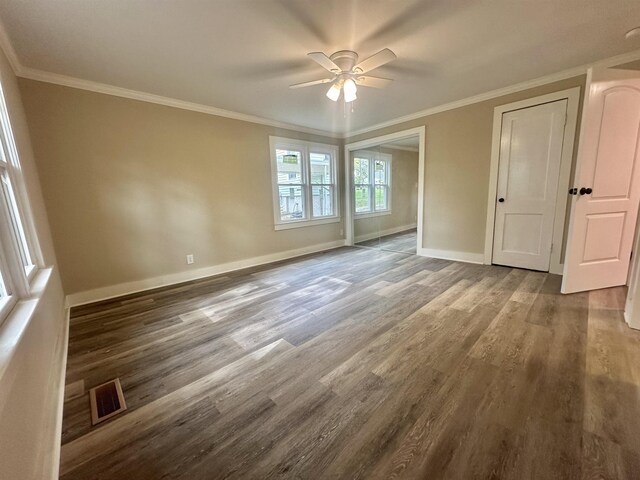 spare room with crown molding, dark hardwood / wood-style flooring, and ceiling fan