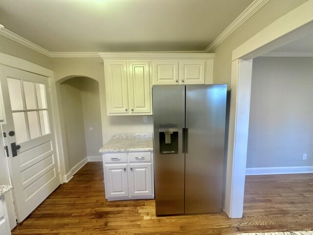 kitchen with white cabinetry, crown molding, wood-type flooring, and stainless steel refrigerator with ice dispenser