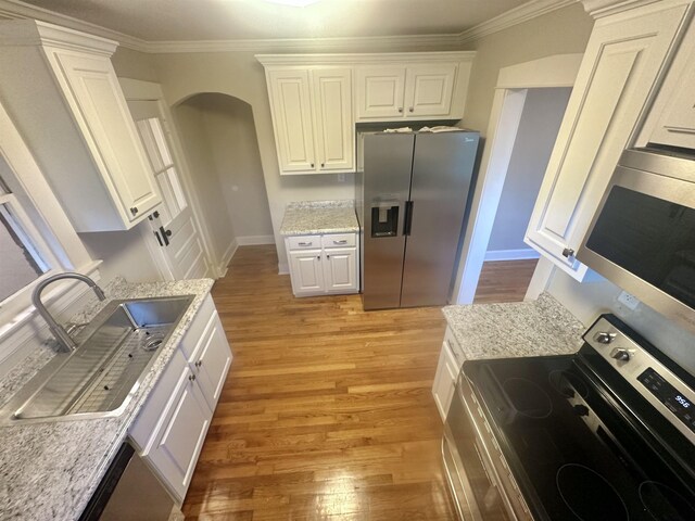 kitchen with crown molding, sink, white cabinets, and appliances with stainless steel finishes