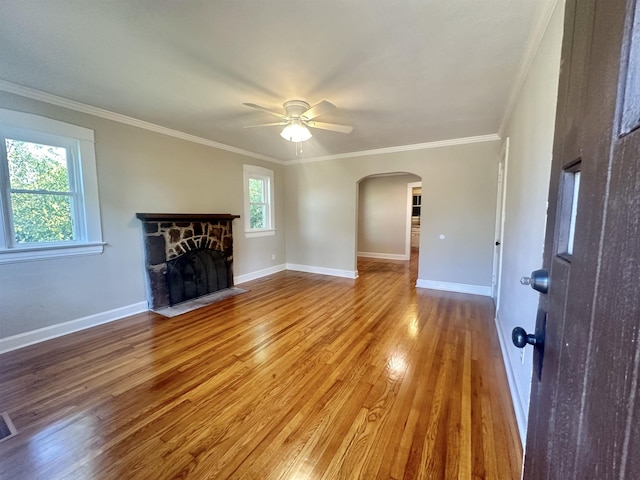 unfurnished living room featuring a fireplace, a wealth of natural light, hardwood / wood-style flooring, and ceiling fan