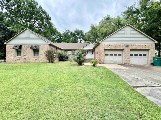 single story home featuring a garage and a front lawn