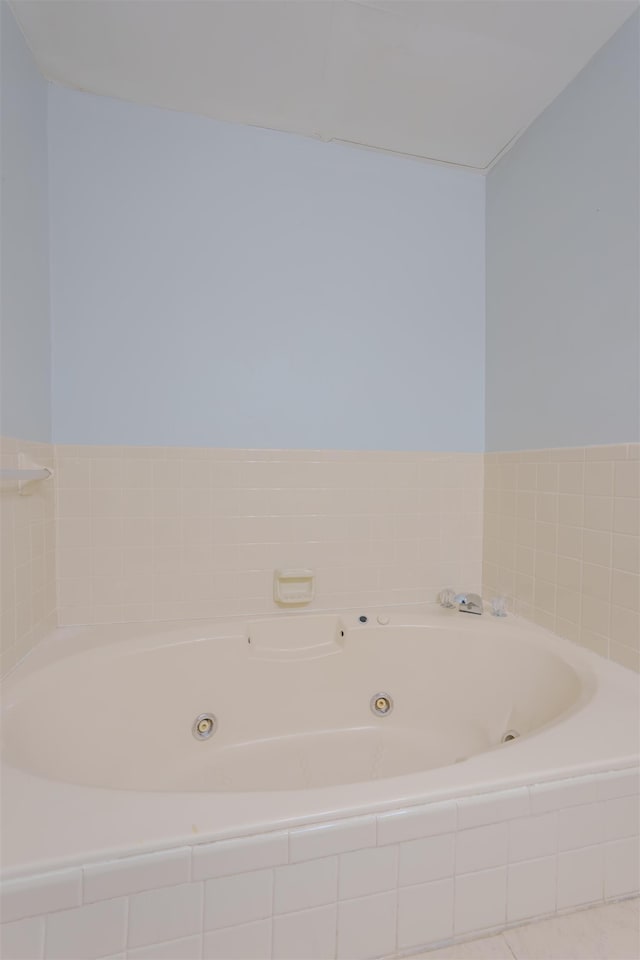 bathroom with a tub with jets