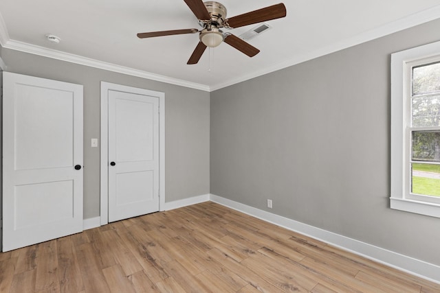  - unfurnished bedroom featuring light wood-style flooring, ornamental molding, and ceiling fan