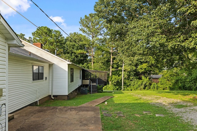  - view of green lawn with view of wooded area