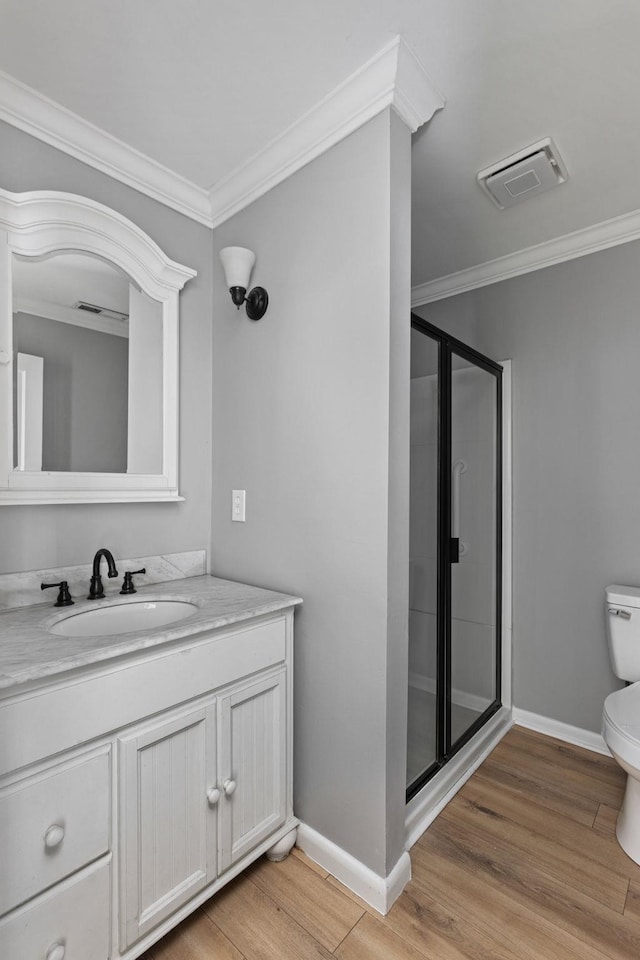  - bathroom with a stall shower, wood finished floors, crown molding, and vanity
