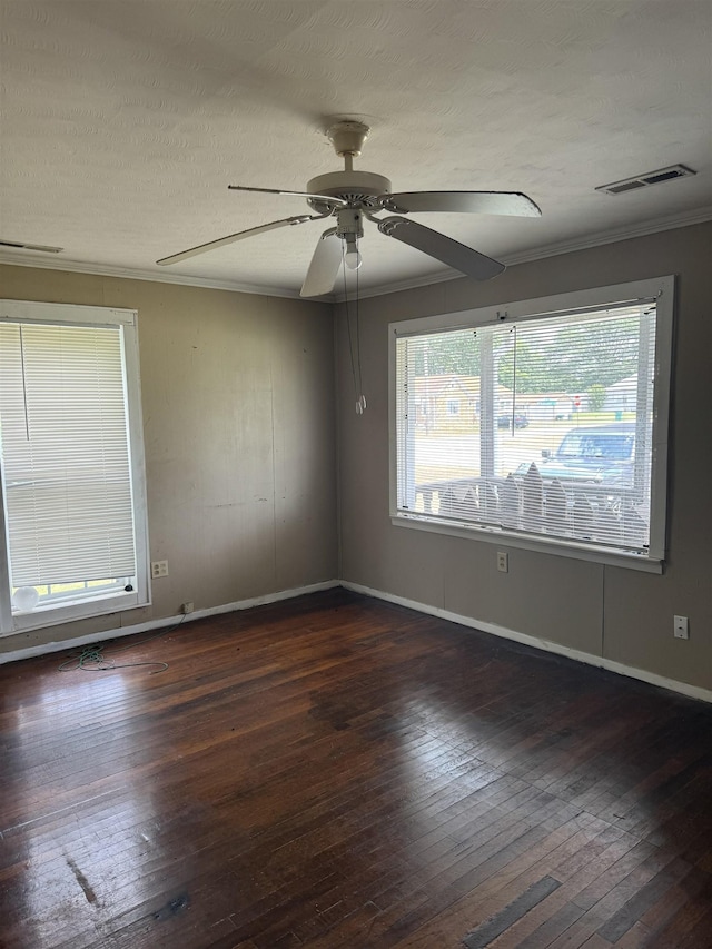 unfurnished room with a textured ceiling, crown molding, ceiling fan, and dark wood-type flooring