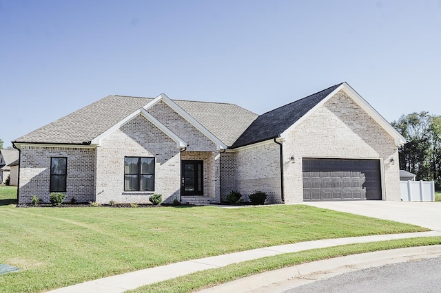 french country home featuring a front yard and a garage