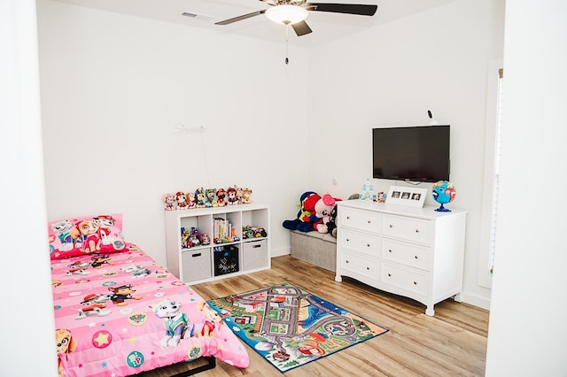 bedroom with ceiling fan and light hardwood / wood-style floors