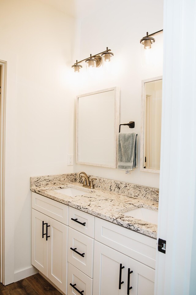 bathroom with vanity and hardwood / wood-style flooring