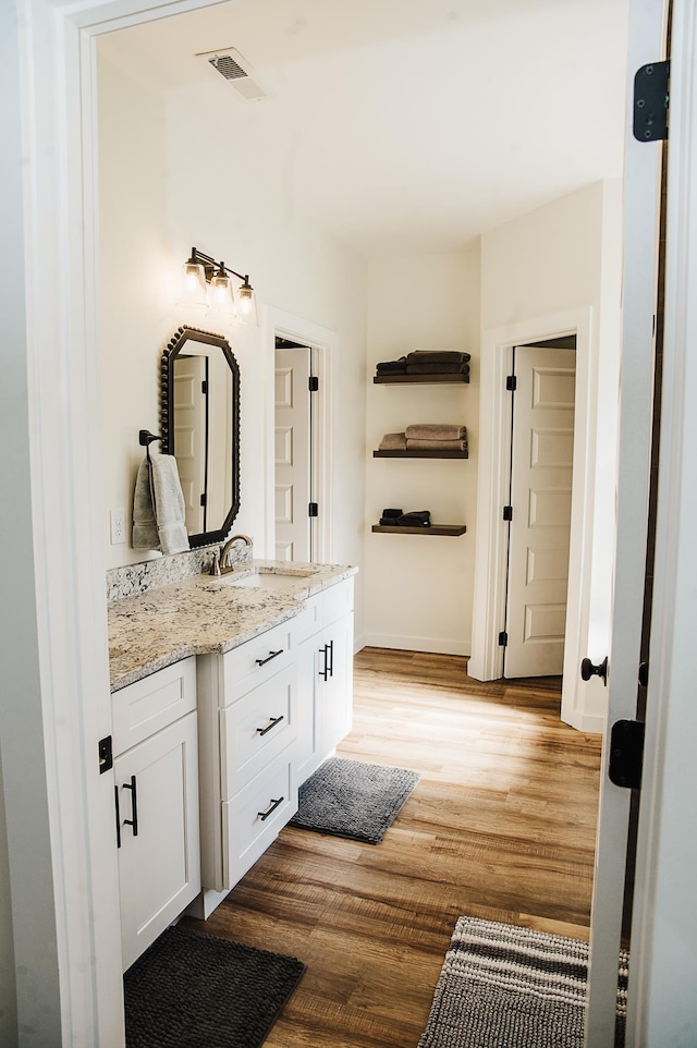 bathroom with vanity and wood-type flooring