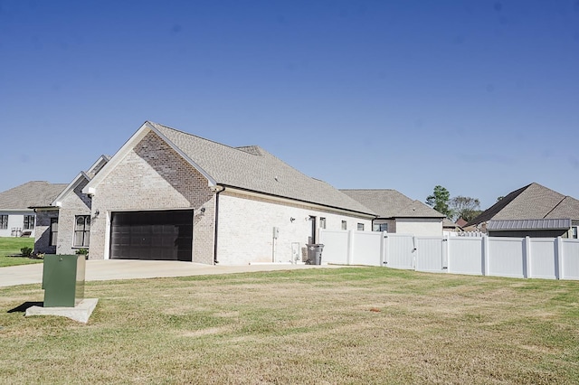 view of property exterior featuring a yard and a garage