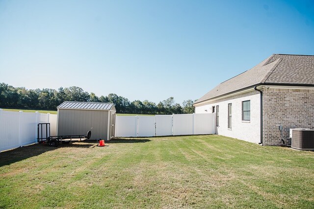 view of yard with a storage unit and central air condition unit