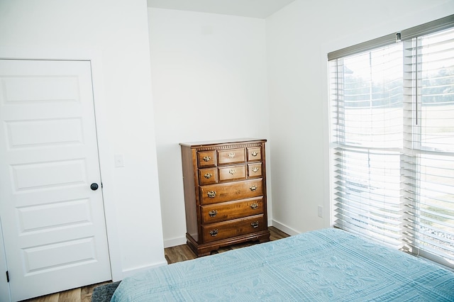 bedroom with dark wood-type flooring