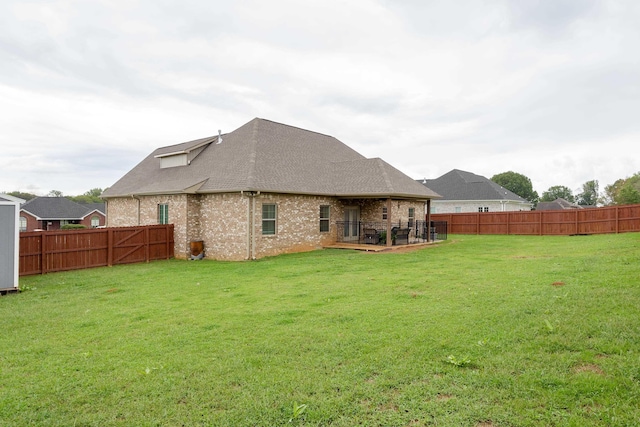 back of house featuring a yard