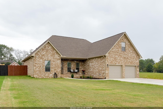 view of front of house with a garage and a front lawn