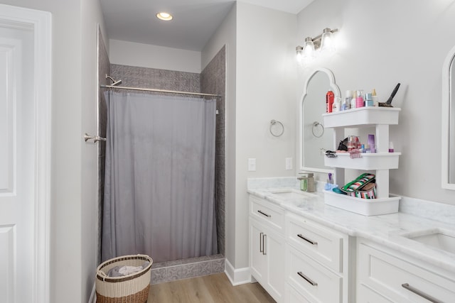 bathroom featuring hardwood / wood-style flooring, vanity, and curtained shower