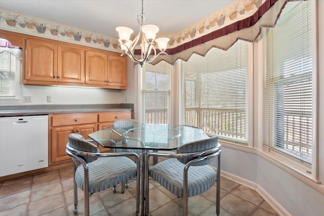 dining space featuring a chandelier and baseboards