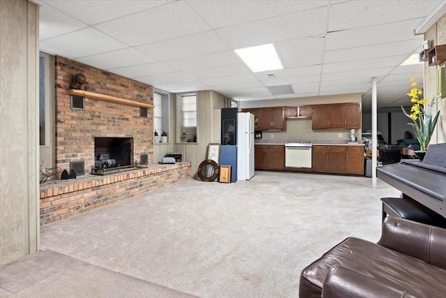 living room with light colored carpet, a fireplace, and a drop ceiling