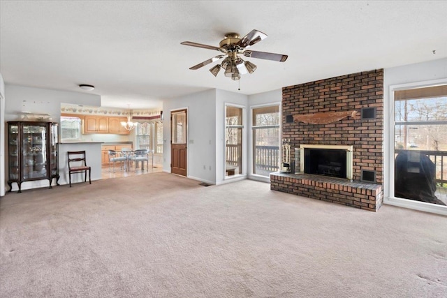 unfurnished living room with light colored carpet, a fireplace, visible vents, and ceiling fan