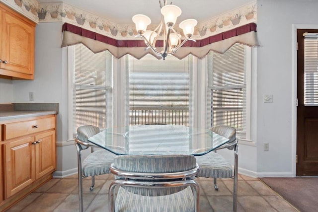 dining room featuring baseboards and a notable chandelier