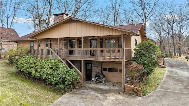 view of front facade featuring an attached garage, brick siding, driveway, stairway, and a chimney