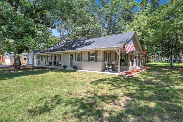 rear view of house featuring a lawn