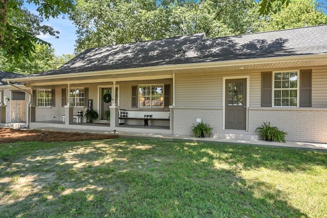 ranch-style house with covered porch and a front yard