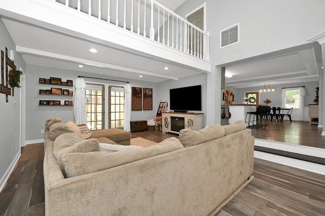 living room featuring dark wood-type flooring and an inviting chandelier