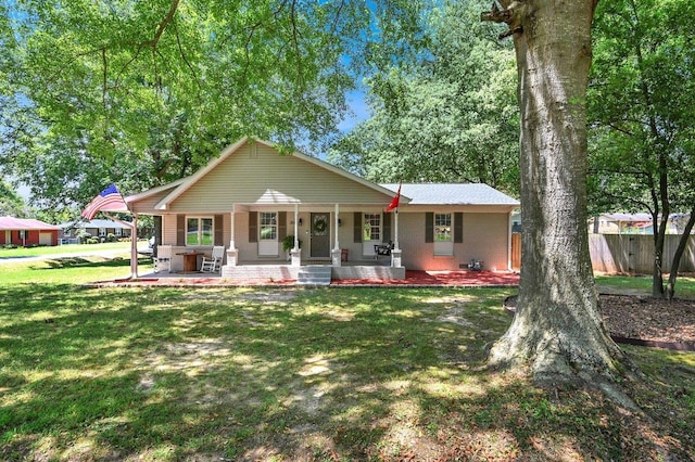 ranch-style house with covered porch and a front lawn