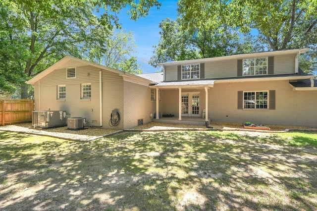 rear view of house featuring french doors and central AC