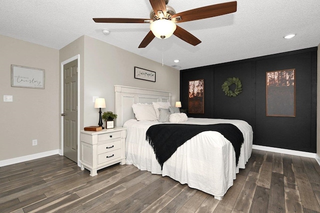 bedroom featuring a textured ceiling, ceiling fan, and dark wood-type flooring