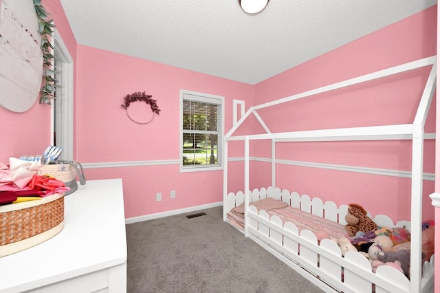 bedroom with carpet and a textured ceiling