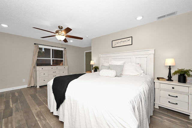 bedroom featuring a textured ceiling, ceiling fan, and dark hardwood / wood-style floors