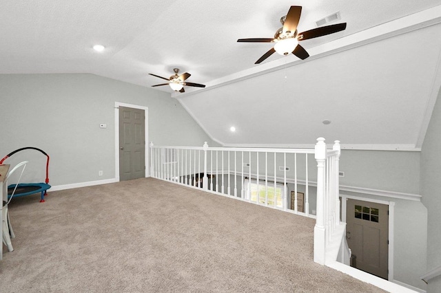 additional living space featuring carpet flooring, ceiling fan, lofted ceiling, and a textured ceiling