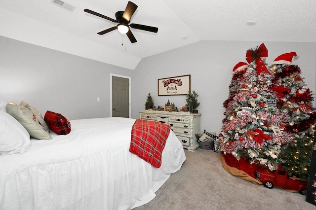 bedroom featuring carpet flooring, ceiling fan, a textured ceiling, and vaulted ceiling