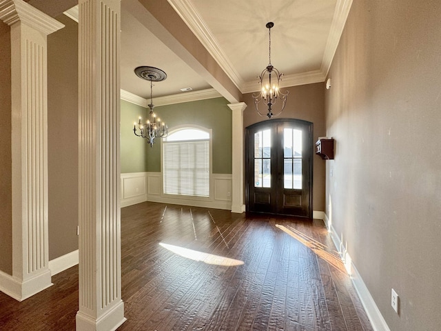 entryway with a chandelier, french doors, dark hardwood / wood-style flooring, and ornamental molding