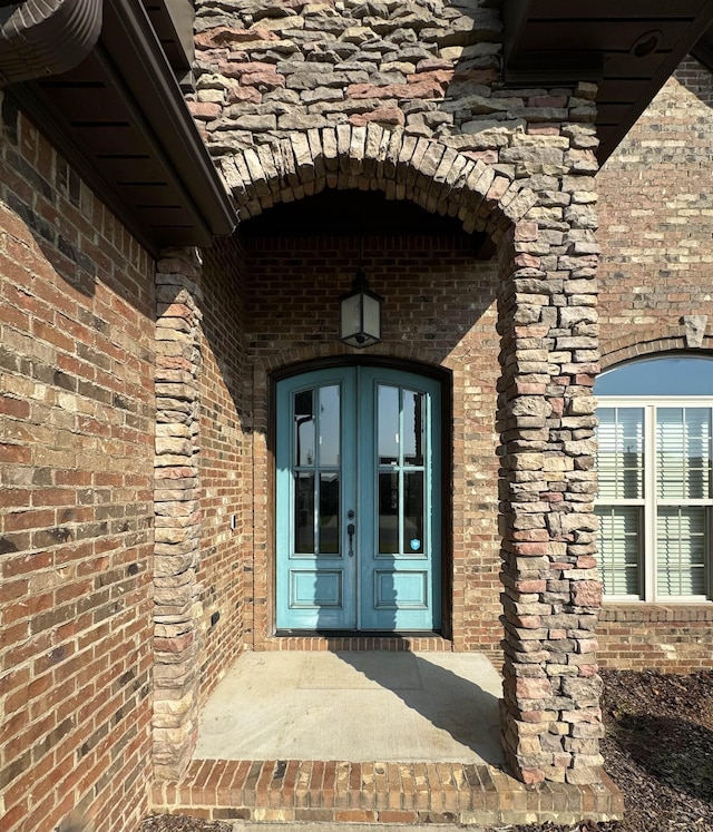 view of exterior entry featuring french doors