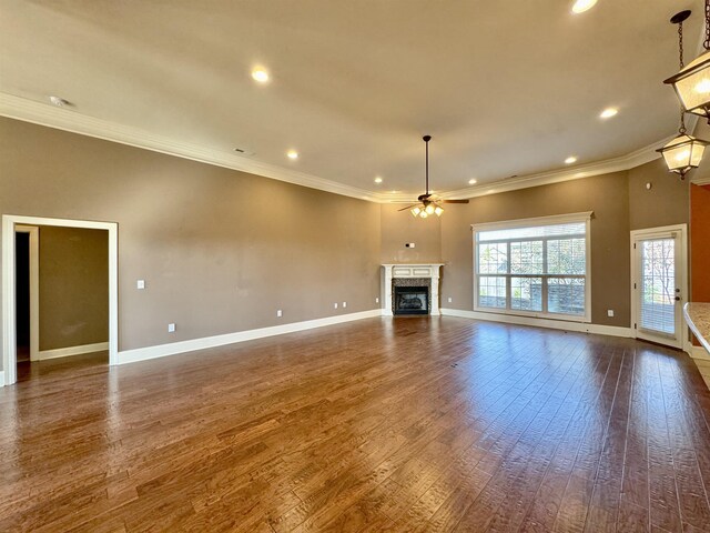 unfurnished living room with dark hardwood / wood-style floors, ceiling fan, and ornamental molding