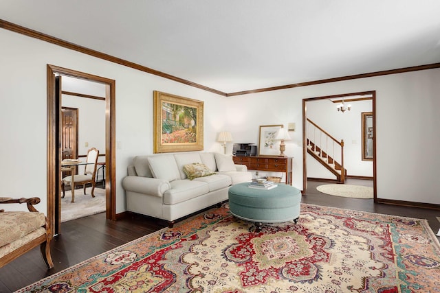 living room with dark hardwood / wood-style flooring, crown molding, and a notable chandelier