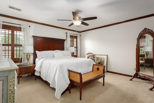 carpeted bedroom featuring ceiling fan and crown molding