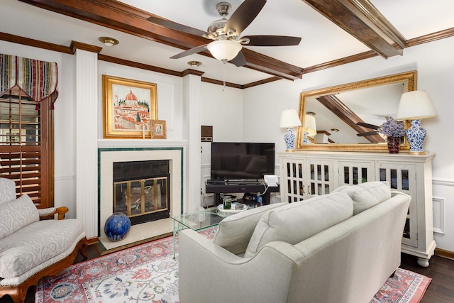 living room with ceiling fan, beamed ceiling, ornamental molding, and hardwood / wood-style flooring