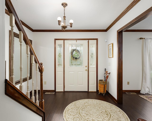 foyer featuring an inviting chandelier, crown molding, and dark hardwood / wood-style floors