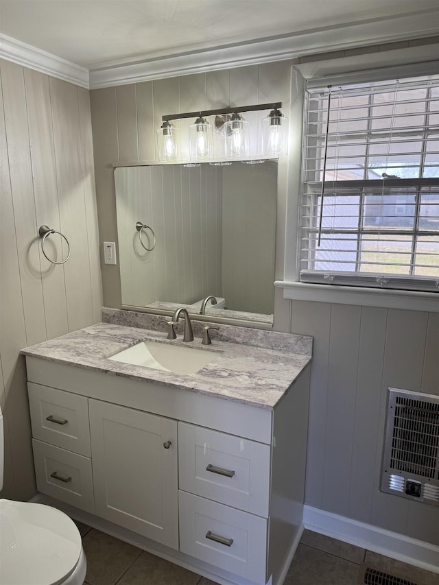 bathroom with toilet, tile patterned floors, heating unit, and vanity