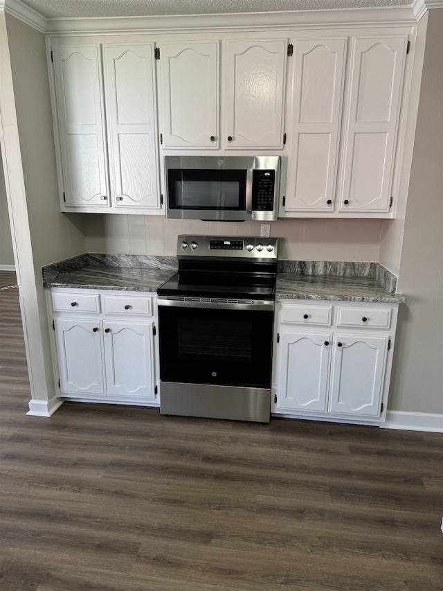 kitchen with stainless steel appliances, dark wood finished floors, and white cabinetry