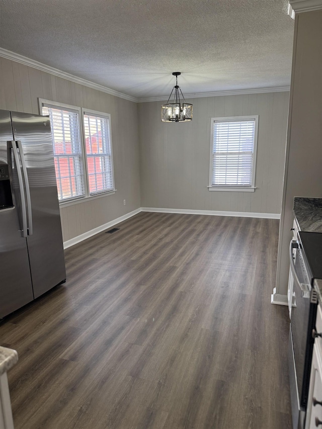 unfurnished dining area with a chandelier, visible vents, crown molding, and dark wood-style flooring