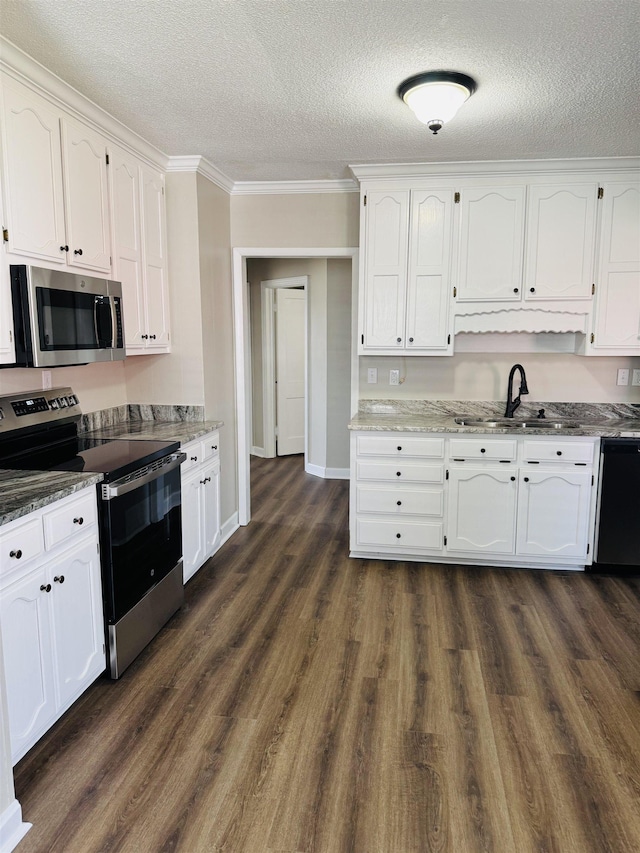 kitchen with white cabinets, appliances with stainless steel finishes, and a sink