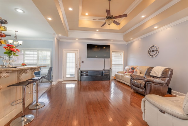  - living area with hardwood / wood-style floors, a ceiling fan, and a chandelier