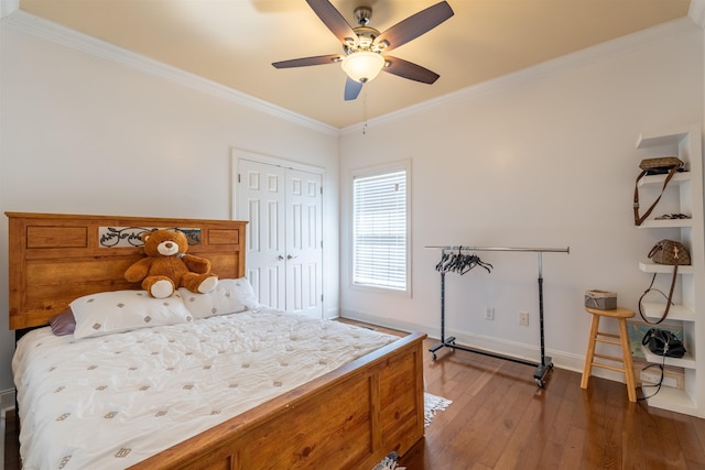  - bedroom featuring crown molding, wood-type flooring, a closet, and ceiling fan