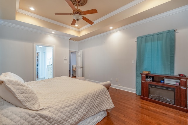  - bedroom with wood finished floors, crown molding, a raised ceiling, recessed lighting, and ceiling fan