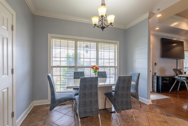  - dining space featuring a chandelier, ornamental molding, and plenty of natural light